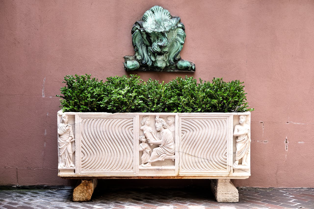 services-01 Elegant bas relief planter with greenery against a classic wall in New York City.